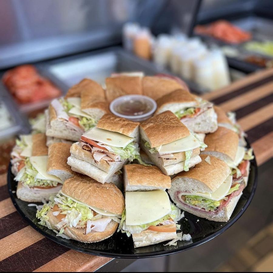 Classic sub platter with assorted subs cut and arranged