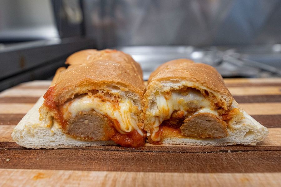 Meatball Parm sub with pork and beef blended meatballs smothered in house red sauce and melted provolone