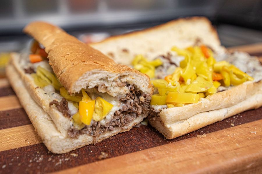 Steak Bomb sub with premium shaved steak, grilled peppers, mushrooms, and caramelized onions covered in melted provolone