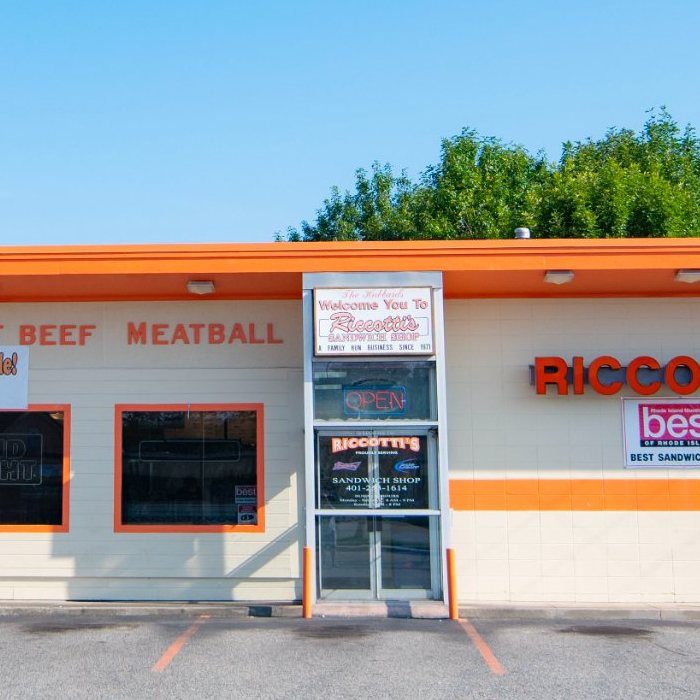 Riccotti's orange building exterior at 11 Gooding Ave Bristol RI showing Best Sandwich Shop award sign